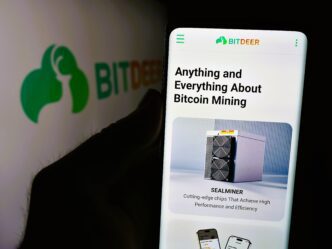 Phone screen displaying the Bitdeer website with information about Bitcoin mining and SEALMINER hardware.