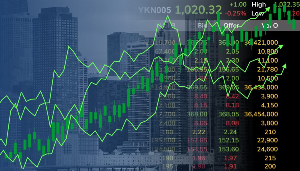 Digital overlay of a green, rising stock market chart and data on a background of blurry skyscrapers.