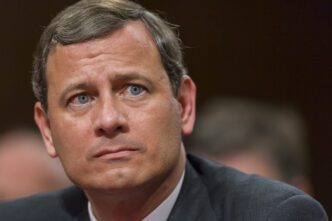 Close-up portrait of the Chief Justice of the United States, John Roberts, looking forward.