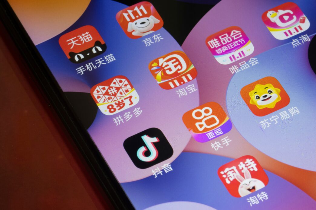Close-up of a smartphone screen showing icons for several popular Chinese e-commerce applications.