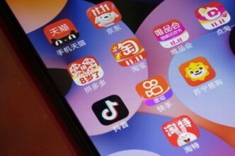 Close-up of a smartphone screen showing icons for several popular Chinese e-commerce applications.
