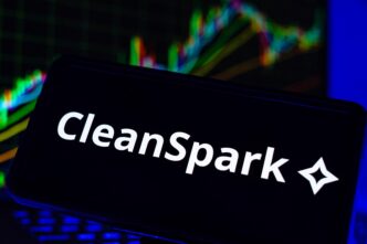 The CleanSpark logo is displayed on a phone screen in front of a colorful, upward-trending financial stock chart.