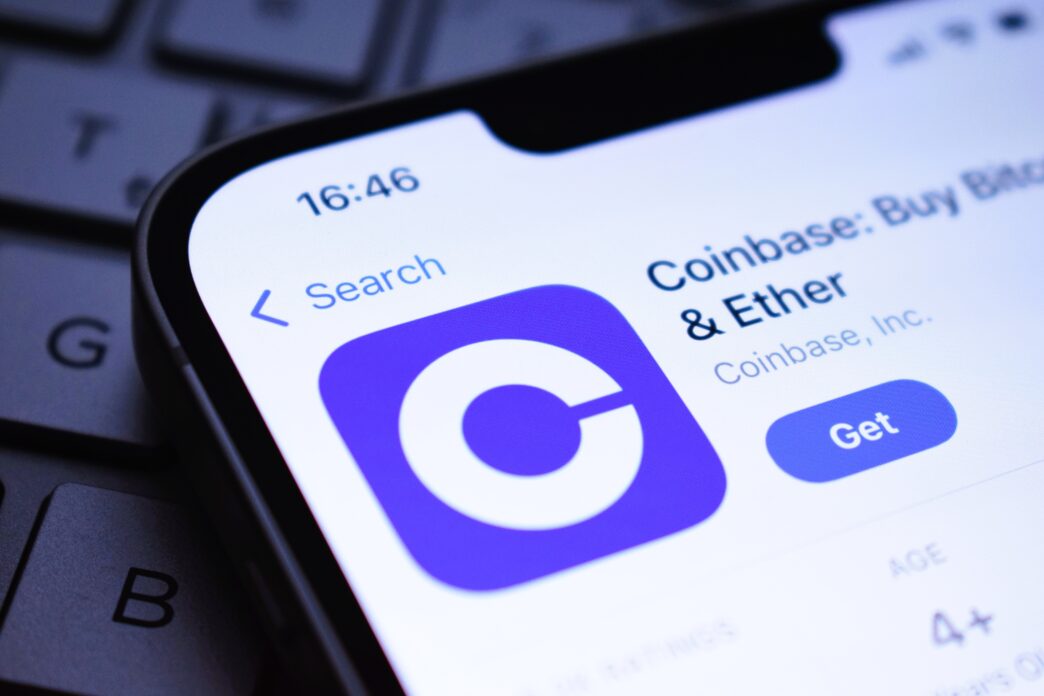 Close-up of a smartphone screen showing the Coinbase app listing in an app store.