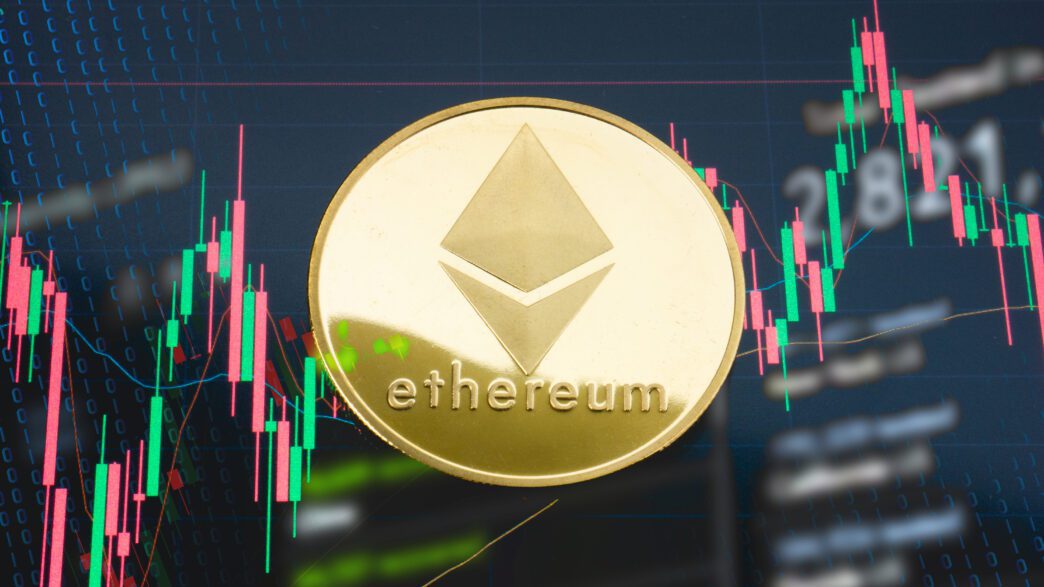 Gold Ethereum coin centered over a screen displaying a green and red candlestick trading chart.