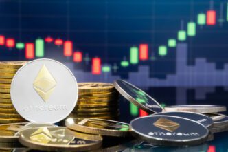 Silver Ethereum coin leaning against stacks of gold crypto coins with a red and green trading chart background.