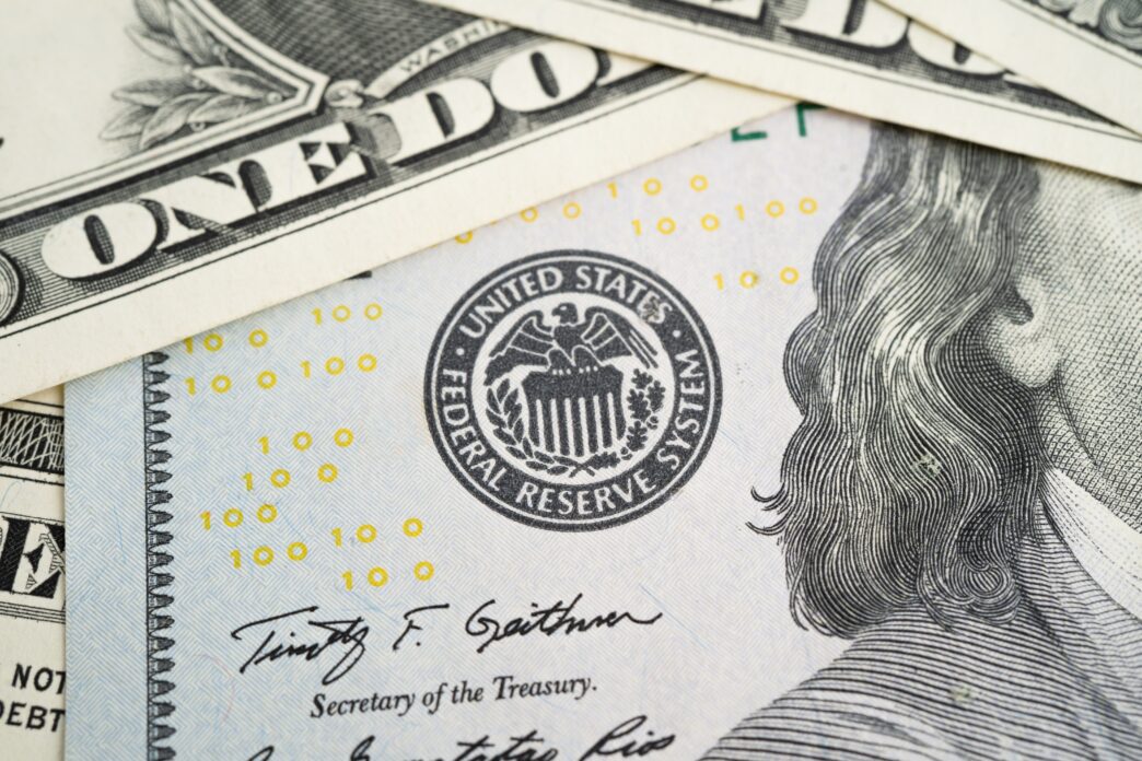 Close-up of a US dollar bill showing the Federal Reserve System seal and a Secretary of the Treasury signature.