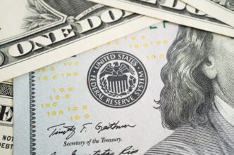 Close-up of a US dollar bill showing the Federal Reserve System seal and a Secretary of the Treasury signature.