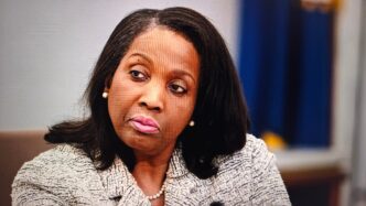 Close-up portrait of Lisa Cook, a Governor of the Federal Reserve System, looking serious.