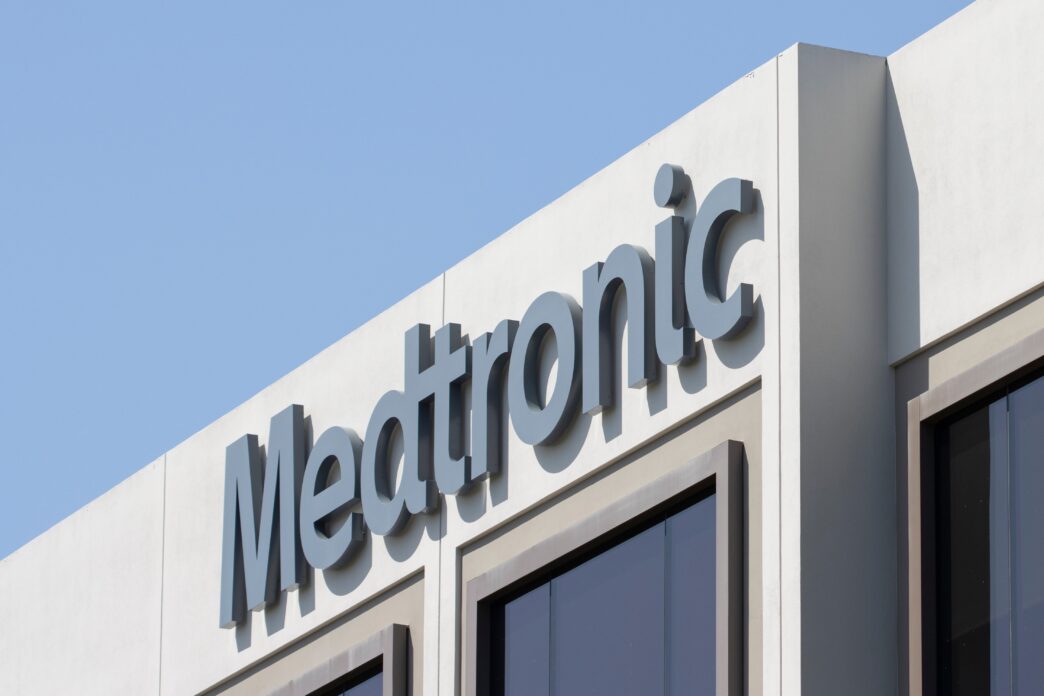 Close-up of the large Medtronic logo sign on the exterior of a corporate office building.
