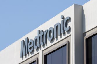 Close-up of the large Medtronic logo sign on the exterior of a corporate office building.
