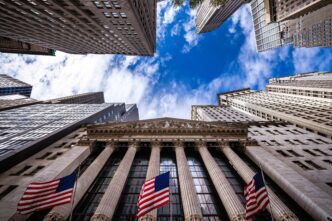 Extreme low-angle view of the New York Stock Exchange building facade and surrounding skyscrapers.