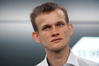 Close-up portrait of Vitalik Buterin, founder of Ethereum, looking intently at the camera.