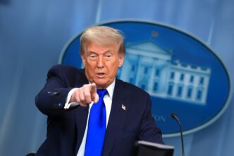 President Trump speaking at a press briefing and pointing directly toward the viewer.