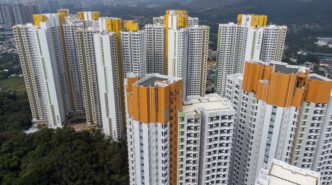 Dense collection of towering, modern public housing skyscrapers in Hong Kong.