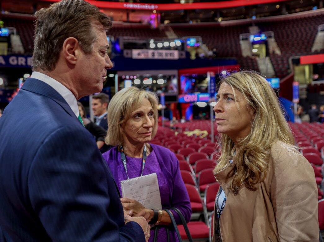 Paul Manafort, Andrea Mitchell, and Deborah Turness talking in an empty arena.
