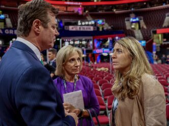 Paul Manafort, Andrea Mitchell, and Deborah Turness talking in an empty arena.
