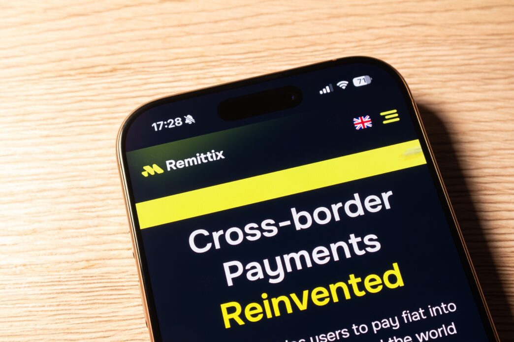 Smartphone screen displaying the Remittix website with the headline "Cross-border Payments Reinvented."