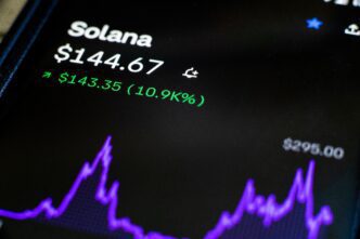 Close-up of a screen displaying a Solana (SOL) cryptocurrency chart, price, and green gains.