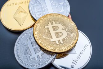 A close-up stack of physical Bitcoin, Ethereum, and Litecoin cryptocurrency coins.