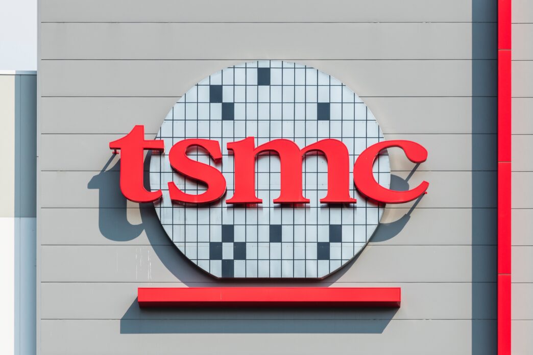 Close-up of the TSMC logo, featuring the red text over a semiconductor wafer graphic.