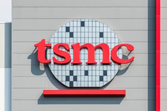 Close-up of the TSMC logo, featuring the red text over a semiconductor wafer graphic.