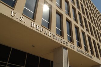 Low-angle view of the inscription "U.S. DEPARTMENT OF EDUCATION" on the building facade.