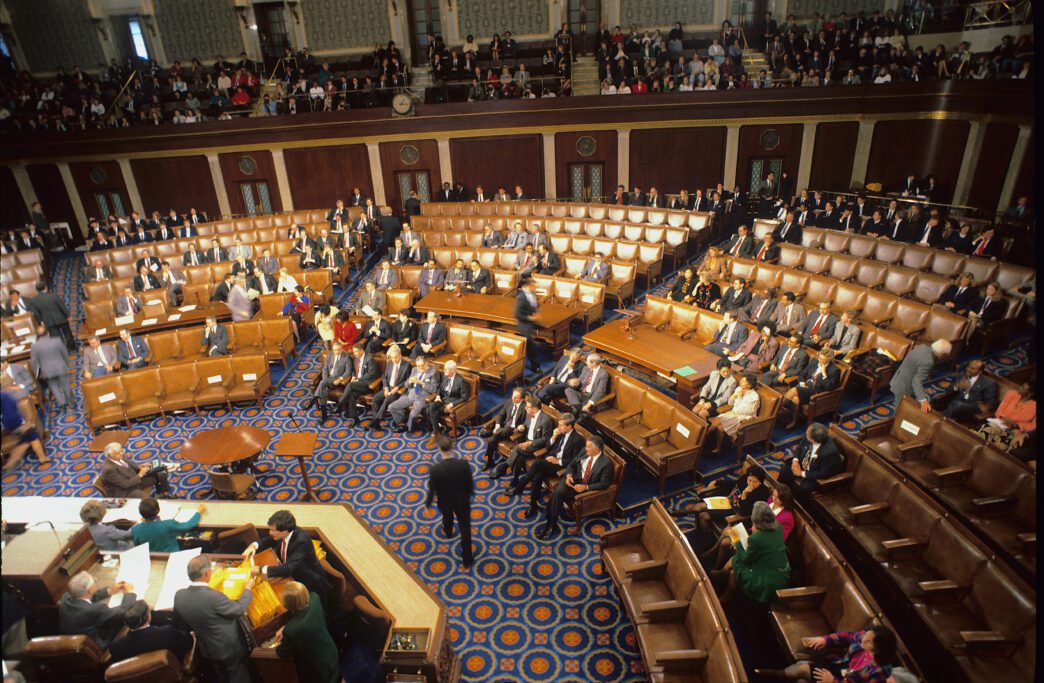 High-angle view of a session of the U.S. House of Representatives with many members seated.