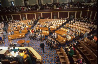 High-angle view of a session of the U.S. House of Representatives with many members seated.