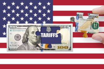 Puzzle piece with the word "TARIFFS" being removed from a $100 bill overlaid on the US flag.