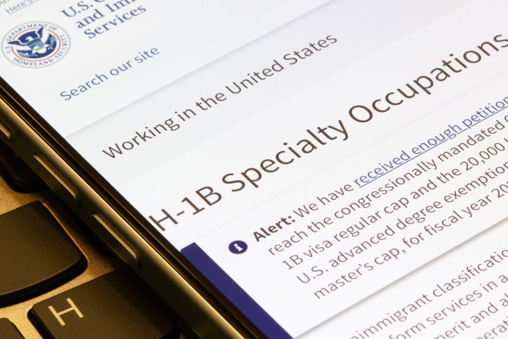 Smartphone screen displaying the U.S. Citizenship and Immigration Services H-1B Visa webpage.