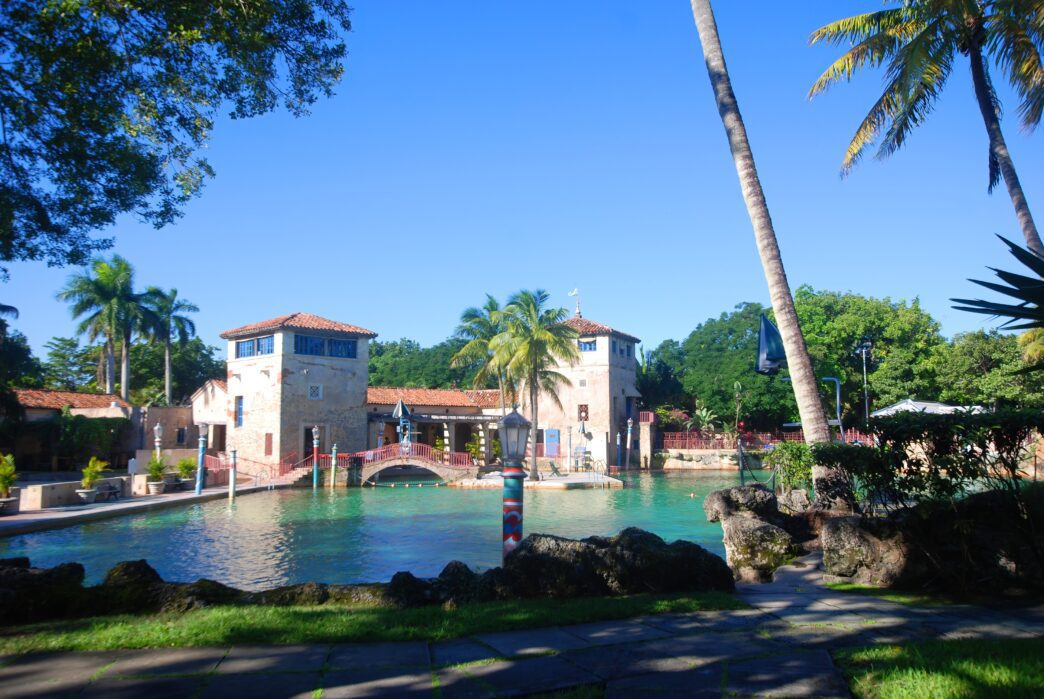 The Venetian Pool in Coral Gables, Florida, featuring historic Mediterranean towers surrounding a clear lagoon.