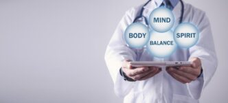 A graphic depicts a balanced scale with a body, mind, and spirit on one side and the word "health" on the other.