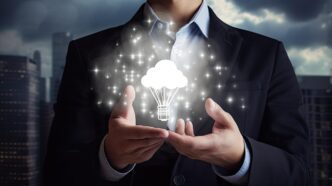 Businessman holding a lightbulb with a cloud icon, representing Generative AI technology.
