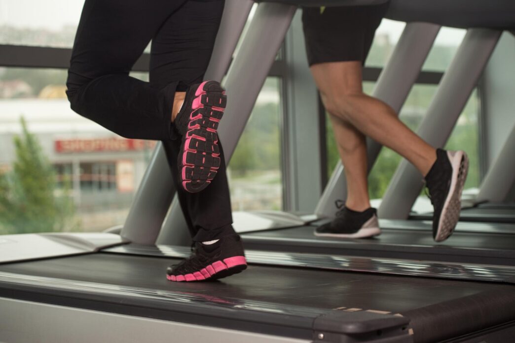 Close-up view of a person exercising on a treadmill.