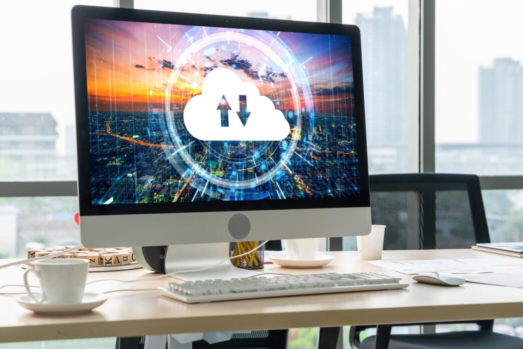 A graphic depicts a laptop computer with cloud icons and lines connecting it to other devices, representing cloud-based remote work.