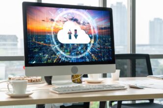 A graphic depicts a laptop computer with cloud icons and lines connecting it to other devices, representing cloud-based remote work.