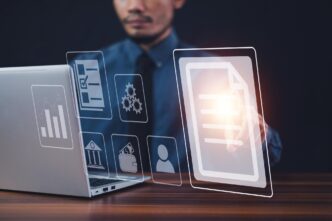 A businessman uses a computer to manage documents online, illustrating the concept of digital file storage and database technology.