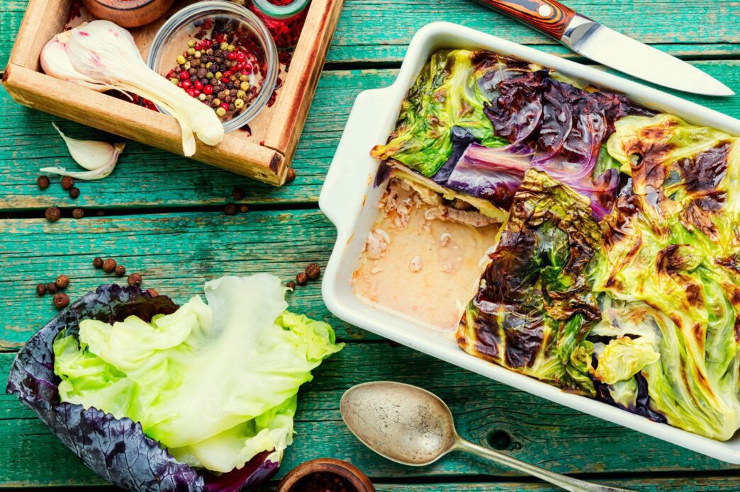 A close-up of a French vegetable gratin featuring cabbage and potatoes.