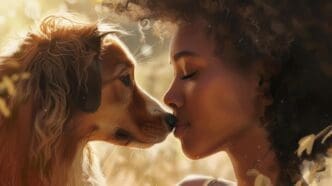 A woman lovingly kisses her dog in a picturesque field.