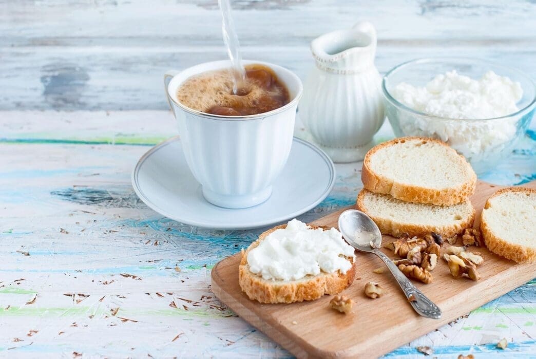 High-angle shot of a table set for breakfast, likely including food and dishes.