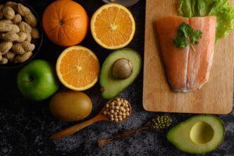 High-angle shot shows various fruits arranged on a wooden cutting board.