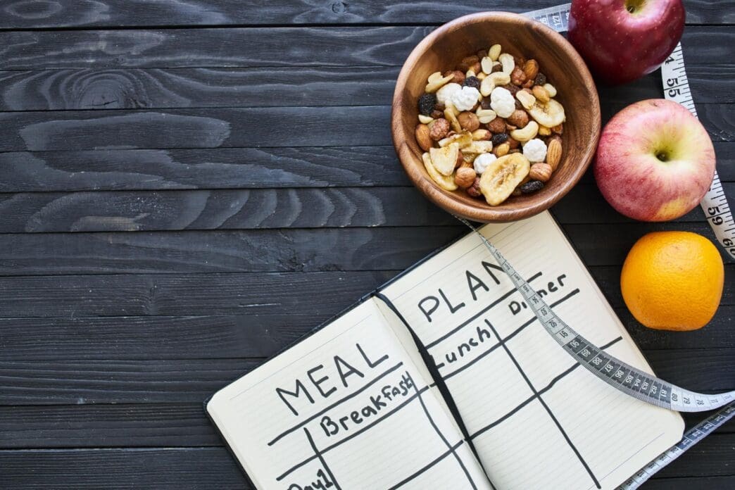 High-angle shot shows an assortment of fruits arranged on a table.