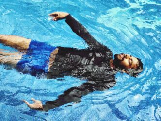 High-angle shot of a man swimming in a pool.