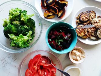 Overhead view shows several bowls of salad arranged on a table.