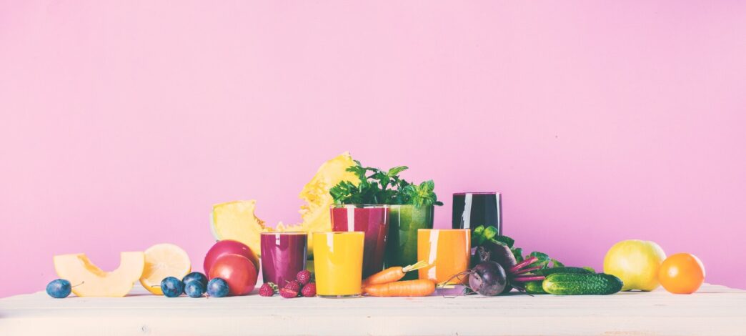 Various glasses filled with colorful smoothies, representing a healthy concept.