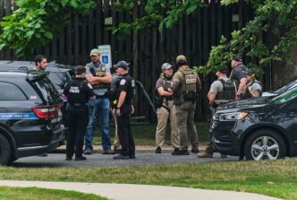 Local police, federal agents, and ICE conducting a tactical operation.