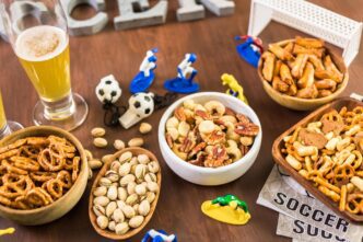 A table displays an assortment of salty snacks and beverages, presumably for a soccer-themed gathering.