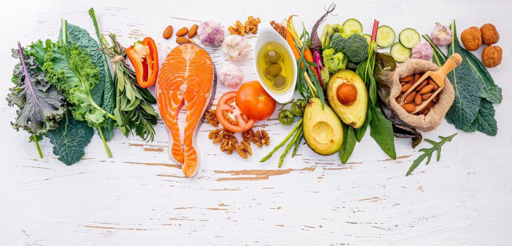 Overhead view shows a collection of diverse food plates arranged against a contrasting black and white background.