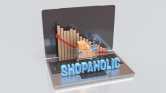 A 3D rendering depicts a laptop screen displaying a shopping cart and a box, symbolizing online shopping.