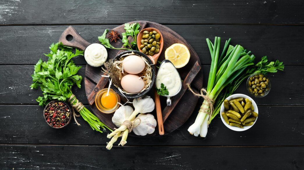 A top-down view shows a small container of white tartar sauce, with empty space surrounding it.